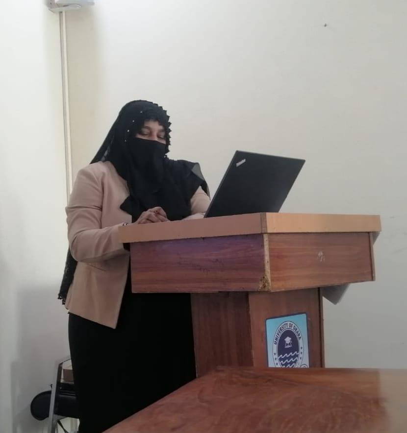 The instructor lecturing at a university podium